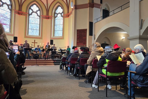 Kirchraum mit Gottesdienstbesuchern von hinten