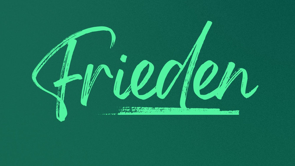 Symbolbild, Schriftzug "Frieden" auf grünem Grund